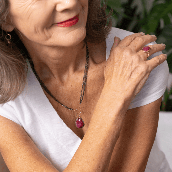 Ruby & Pave Diamond Tear Toggle Necklace, Ruby Wrapped Ring shown on model in white shirt.